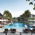 a pool with lounge chairs and umbrellas