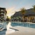 a pool with lounge chairs and umbrellas