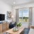 Modern living room connected to kitchen at Silas Park apartments in Savannah, GA.