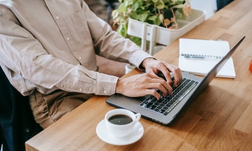 person typing on laptop